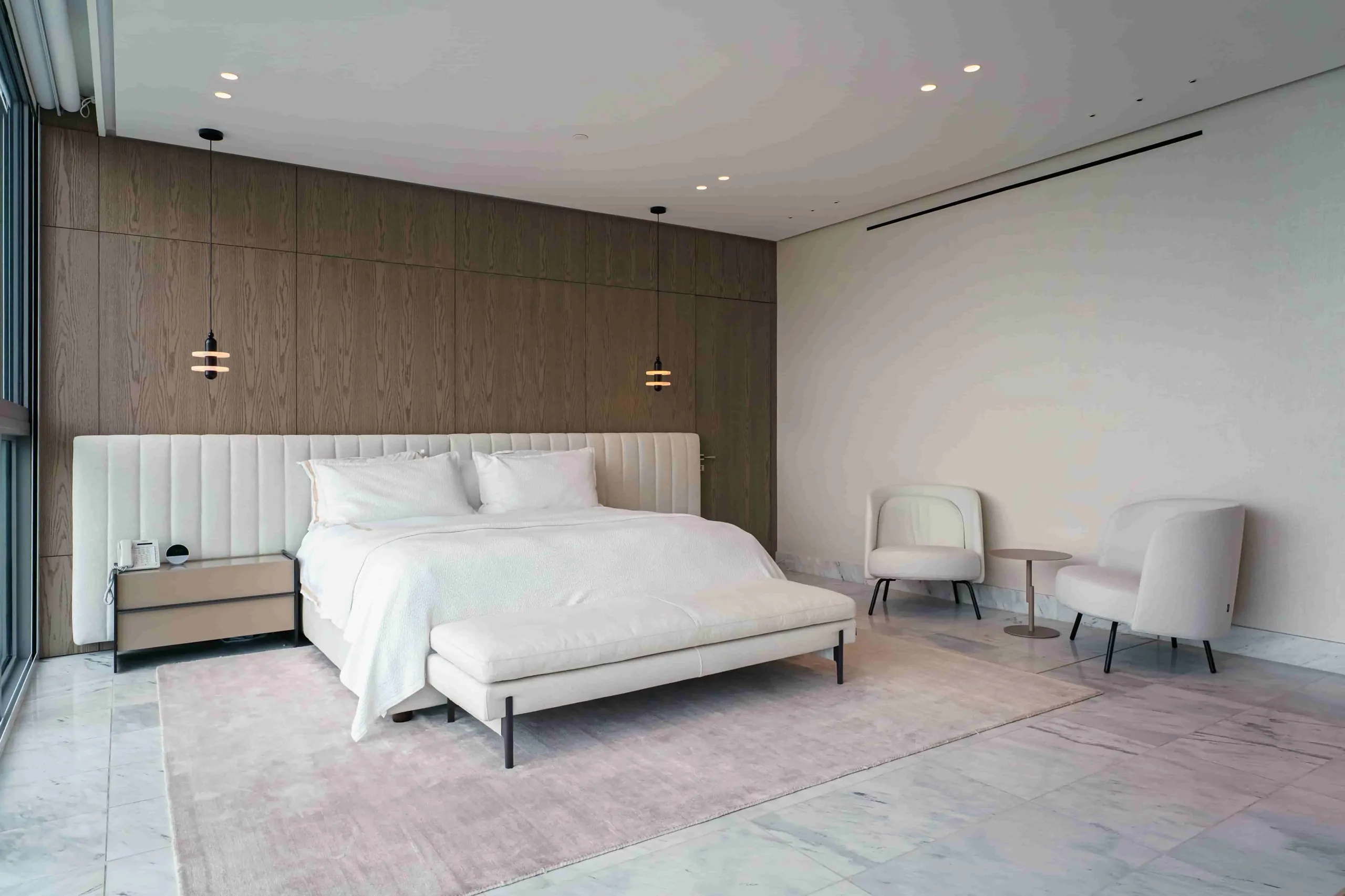 Primary bedroom with an upholstered headboard
