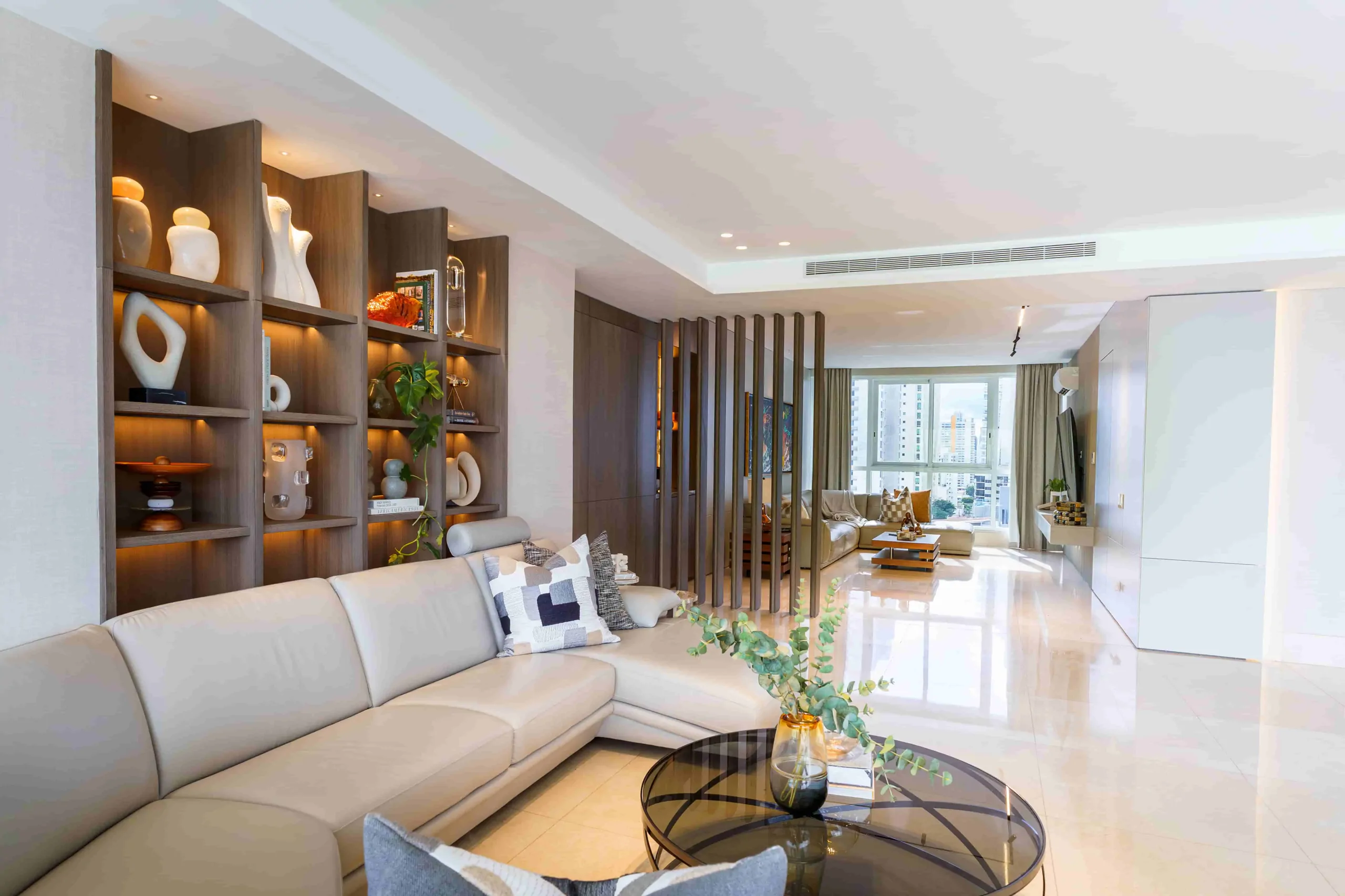 Living room with illuminated shelving and custom furniture